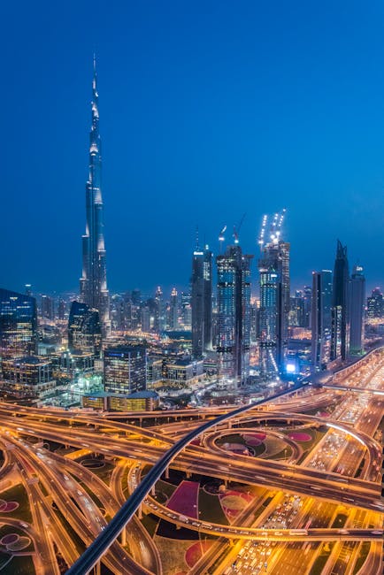 A breathtaking aerial view of Dubai's skyline with Burj Khalifa lit at night.